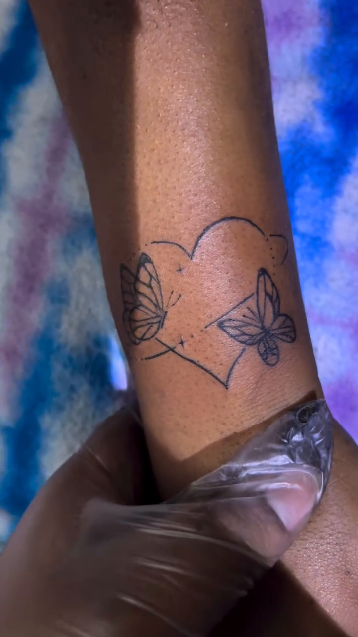 Heart with butterflies fine line tattoo on the forearm by ๐ฆ