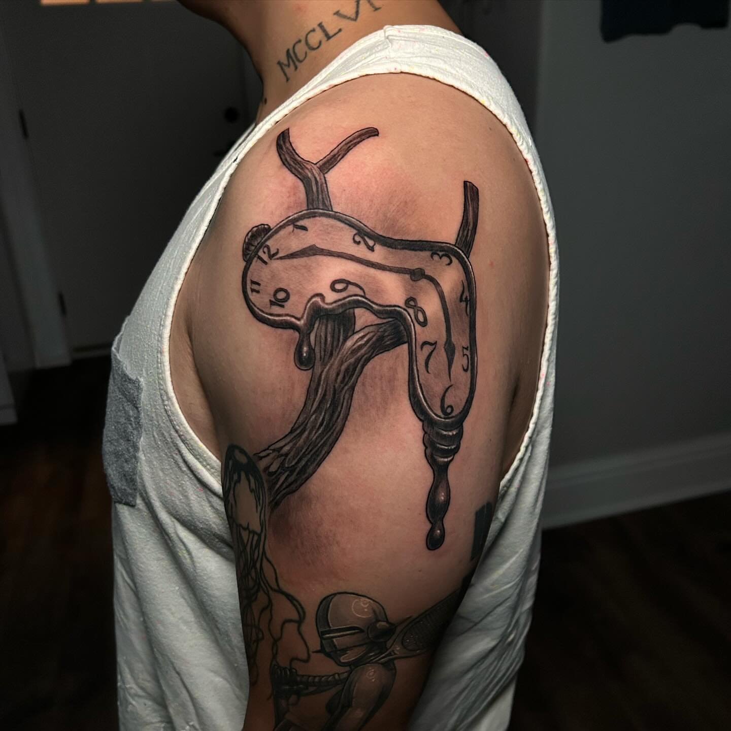 Melting clock surrealism tattoo on the shoulder by Marvin Silva