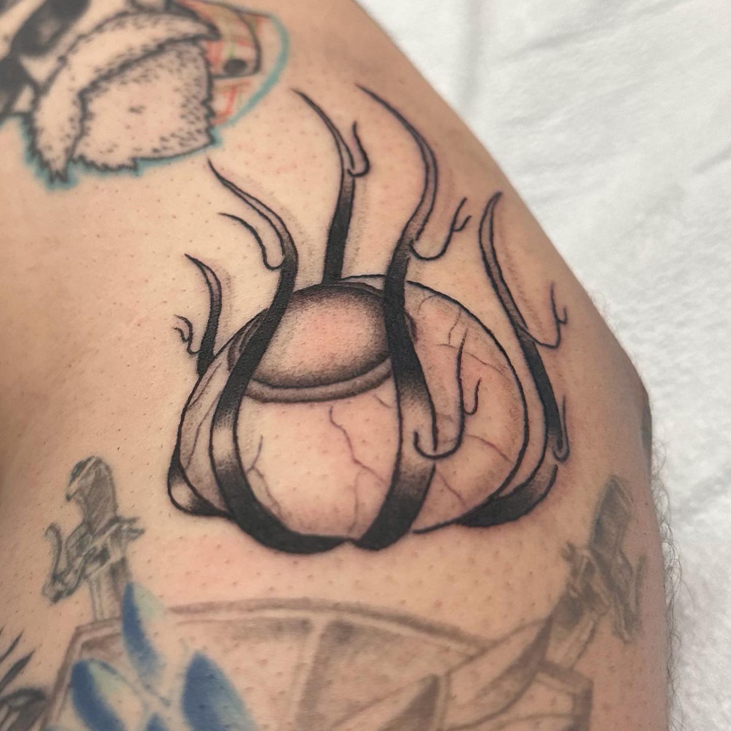 Flame and sphere black and grey tattoo on the shoulder by Mika