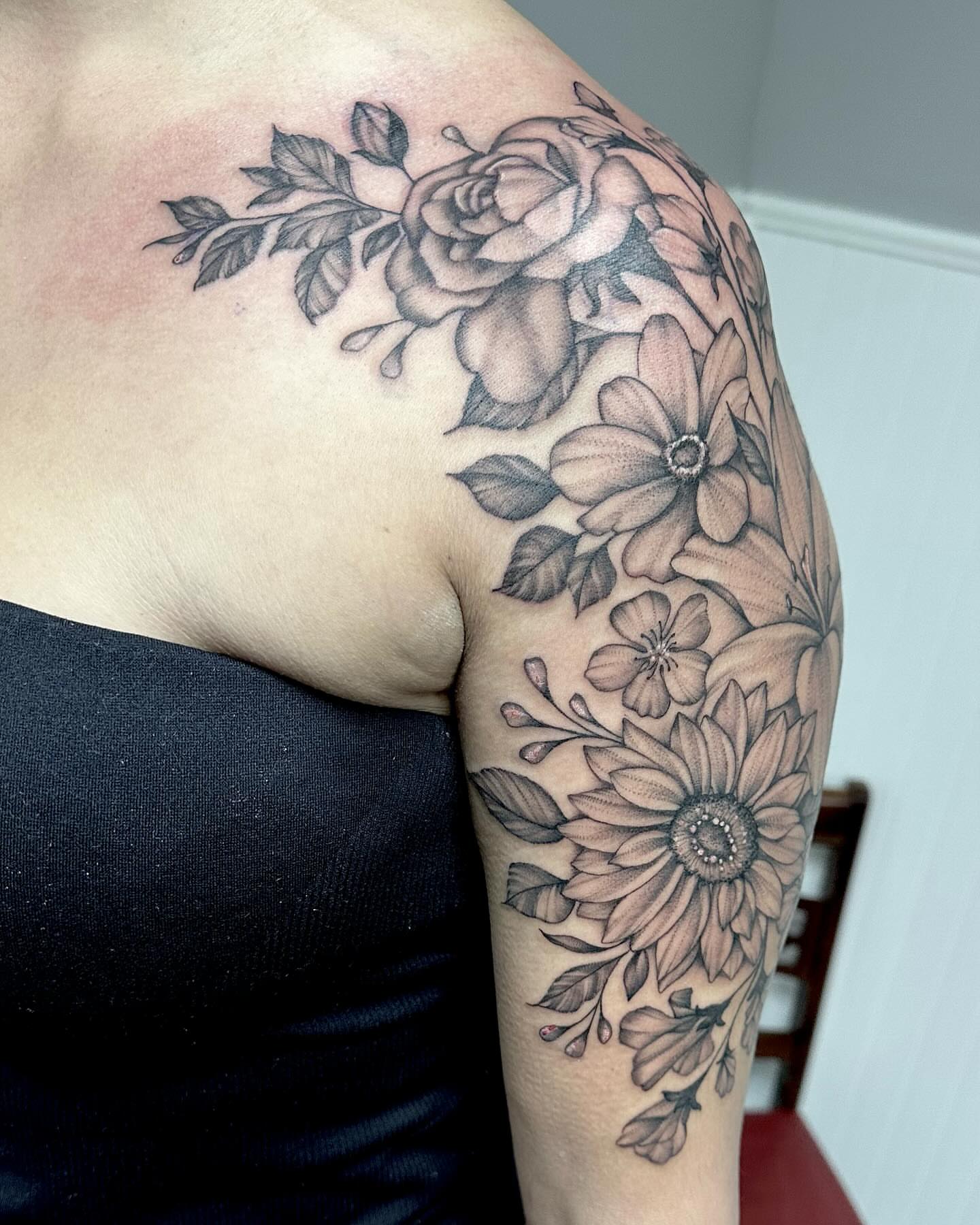 Floral arrangement realism tattoo on the shoulder by Kate Darling