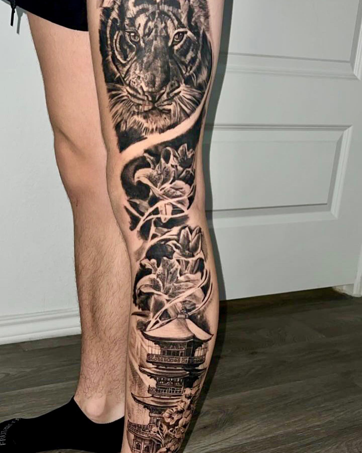Tiger and lotus realism tattoo on the calf by Dre Ortiz