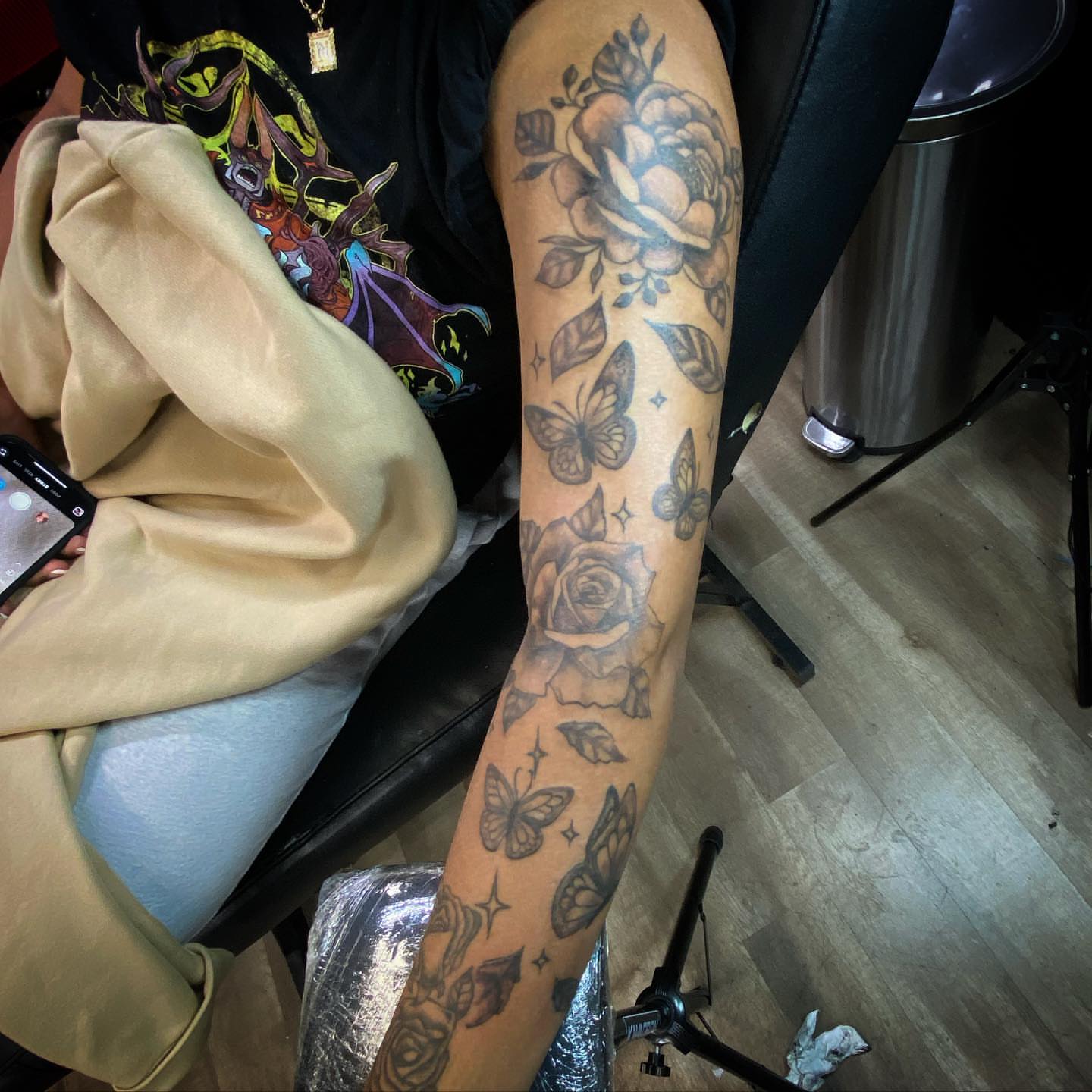 Roses and butterflies black and grey tattoo on the forearm by Erasmo Vasquez