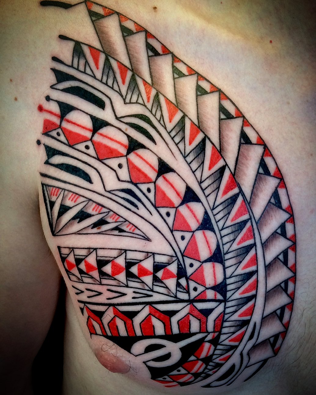 Tribal fern tribal tattoo on the chest by @colorrobbie