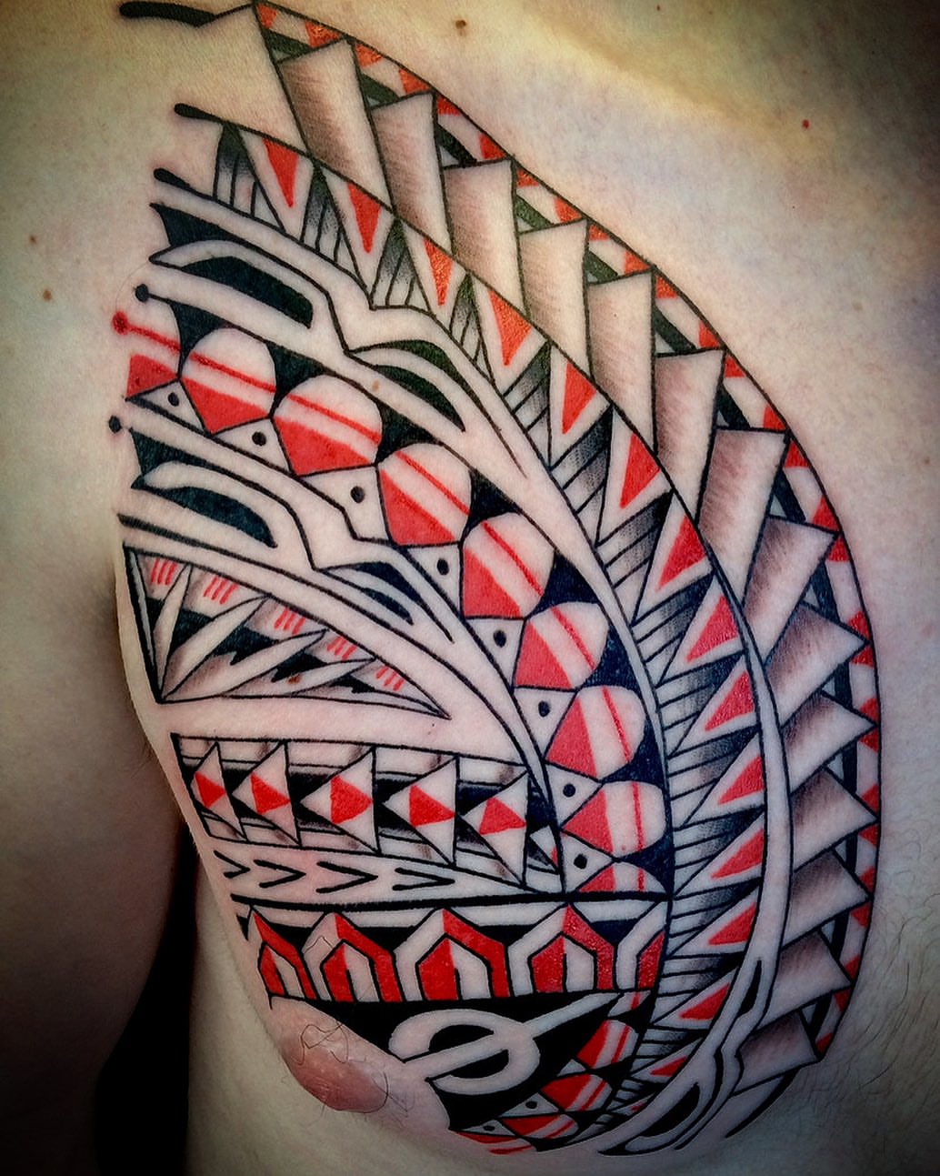 Tribal feather tribal tattoo on the chest by @colorrobbie