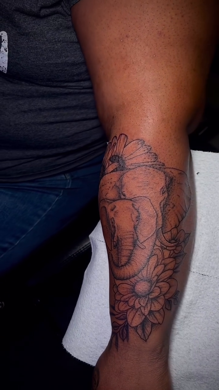 Elephant and flowers realism tattoo by Marques Neal