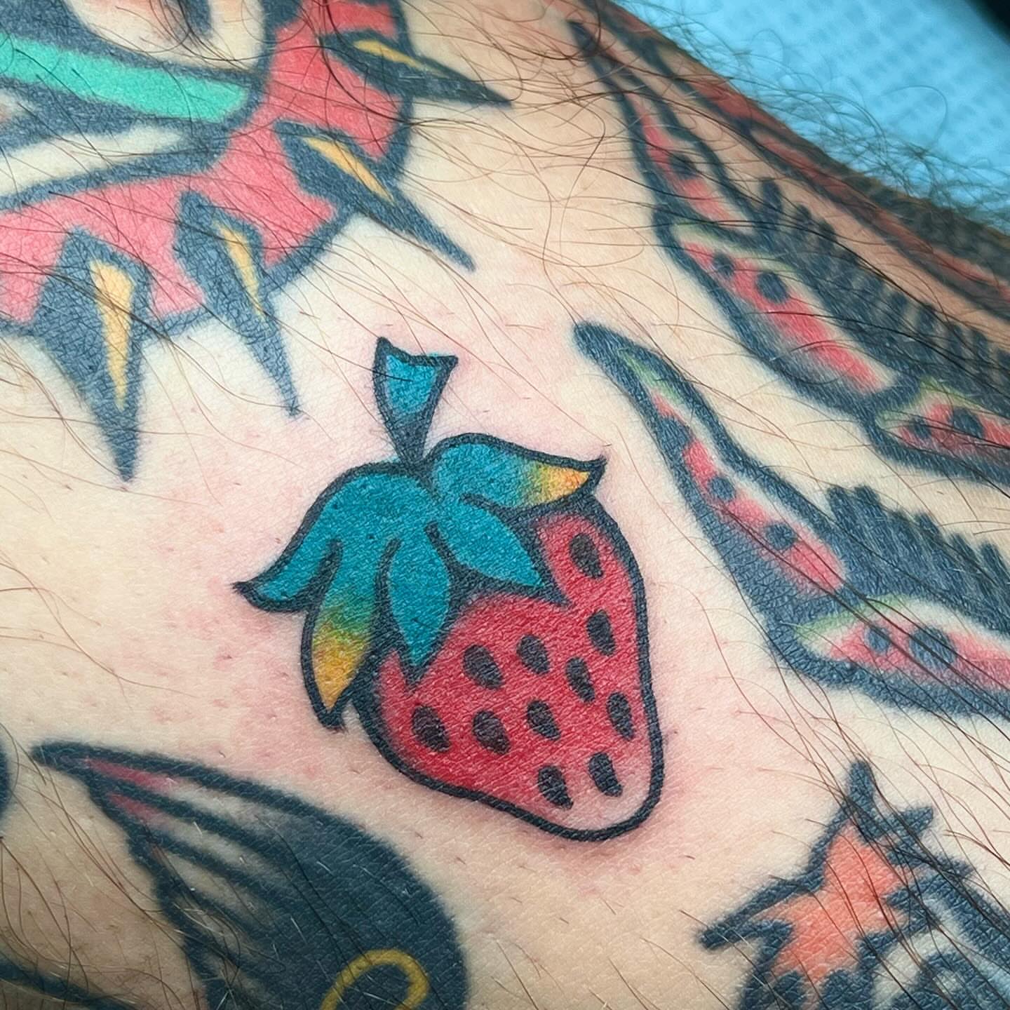 Strawberry American traditional tattoo on the upper arm by 🍓miranda joon bradbury🍓