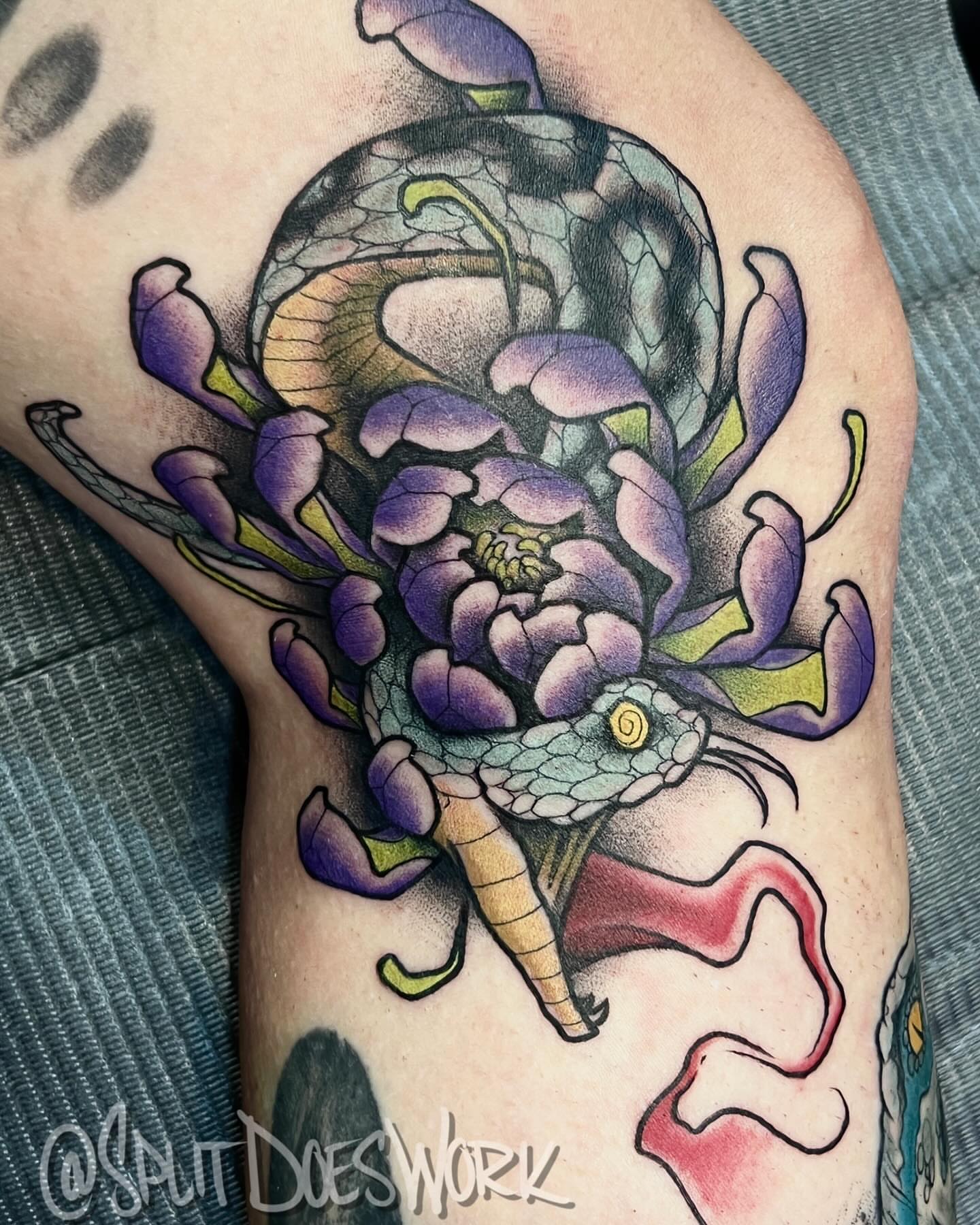 Snake and flower realism tattoo on the forearm by Geoff “Split” DiVittorio