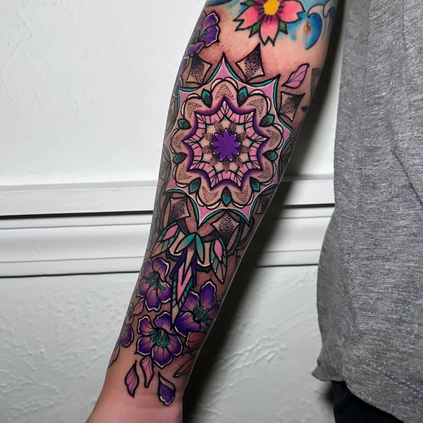 Mandala with floral elements dotwork tattoo on the forearm by Naysla Droguett