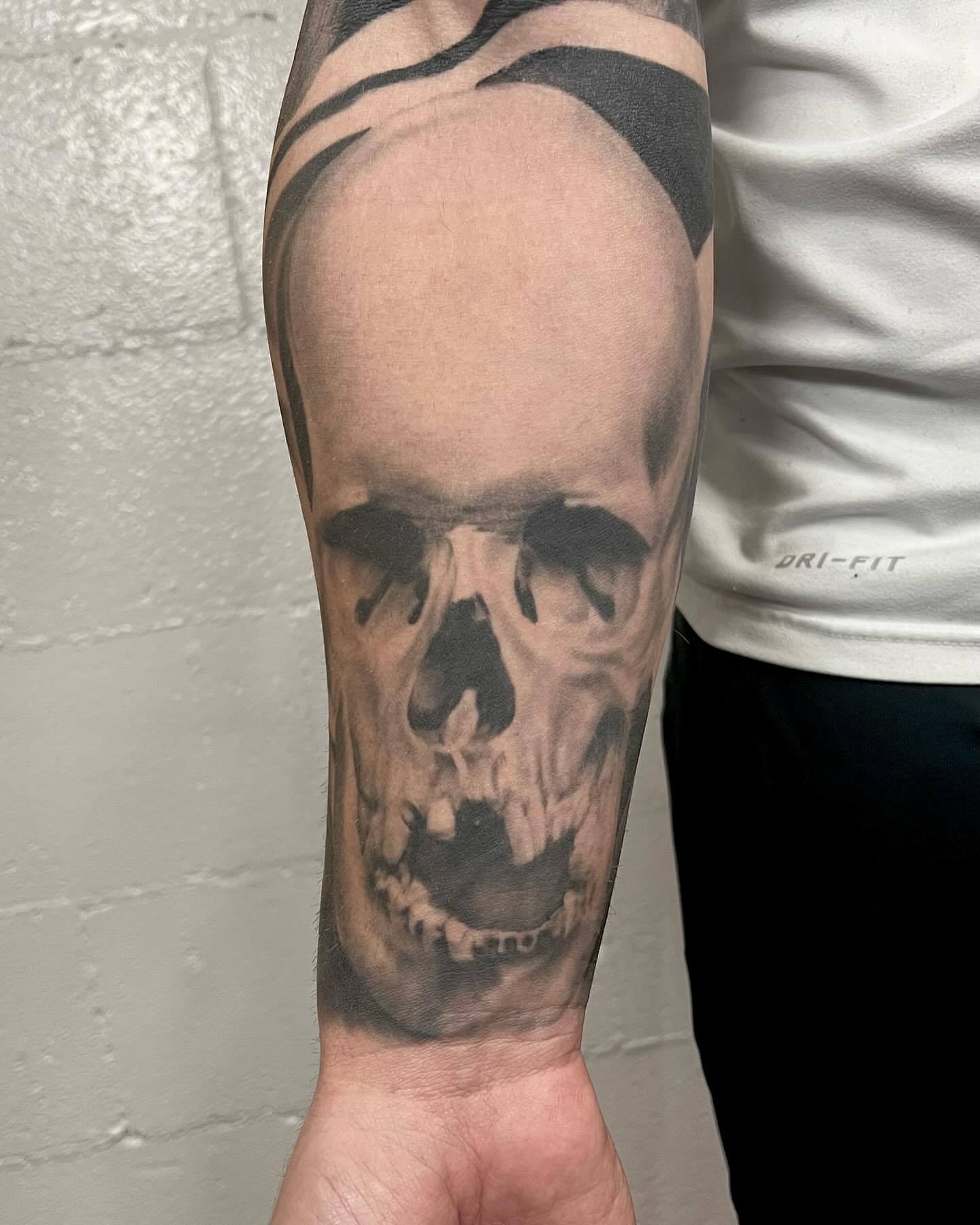 Skull realism tattoo on the forearm by Drew Foster, Toledo, Ohio