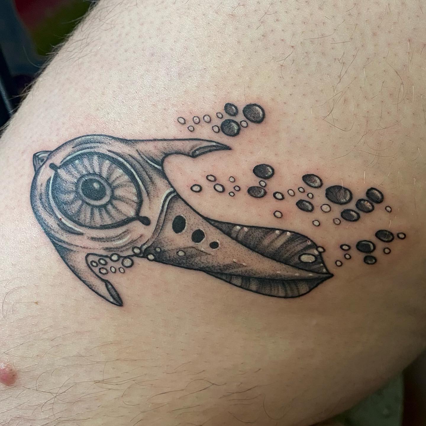 Whale dotwork tattoo on the upper arm by Maddie Neibert