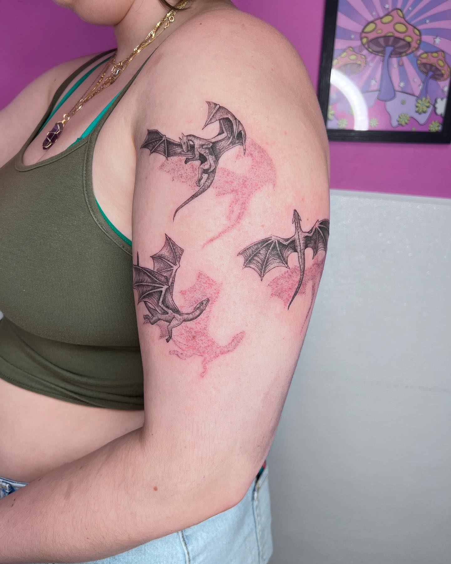 Dragons black and grey tattoo on the upper arm by Jakki Hicks