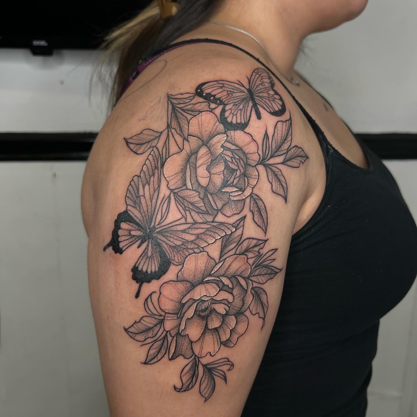 Flowers and butterflies realism tattoo on the shoulder by Kayla Cordova