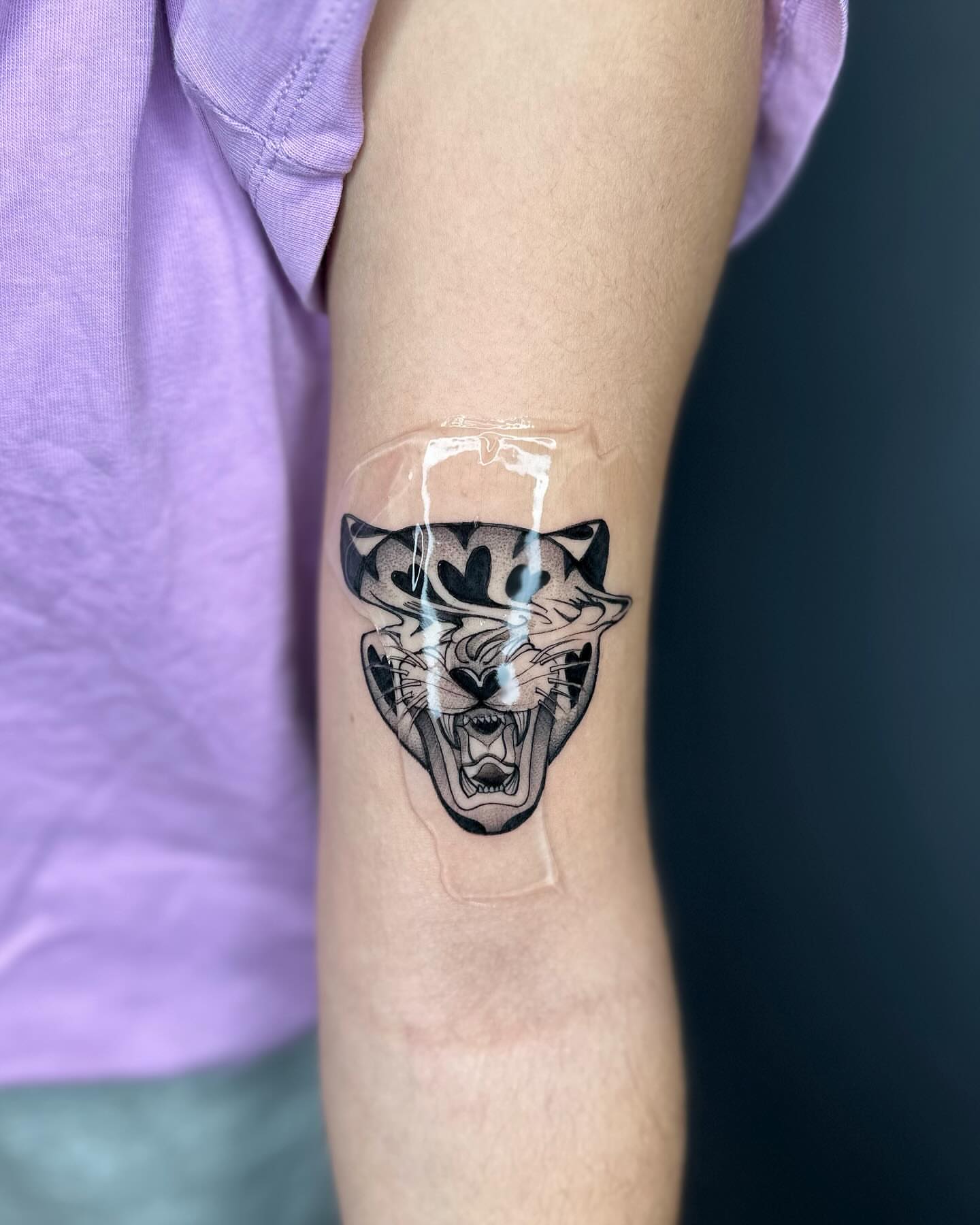 Roaring panther black and grey tattoo on the forearm by Alejo Ibanez Tattoo