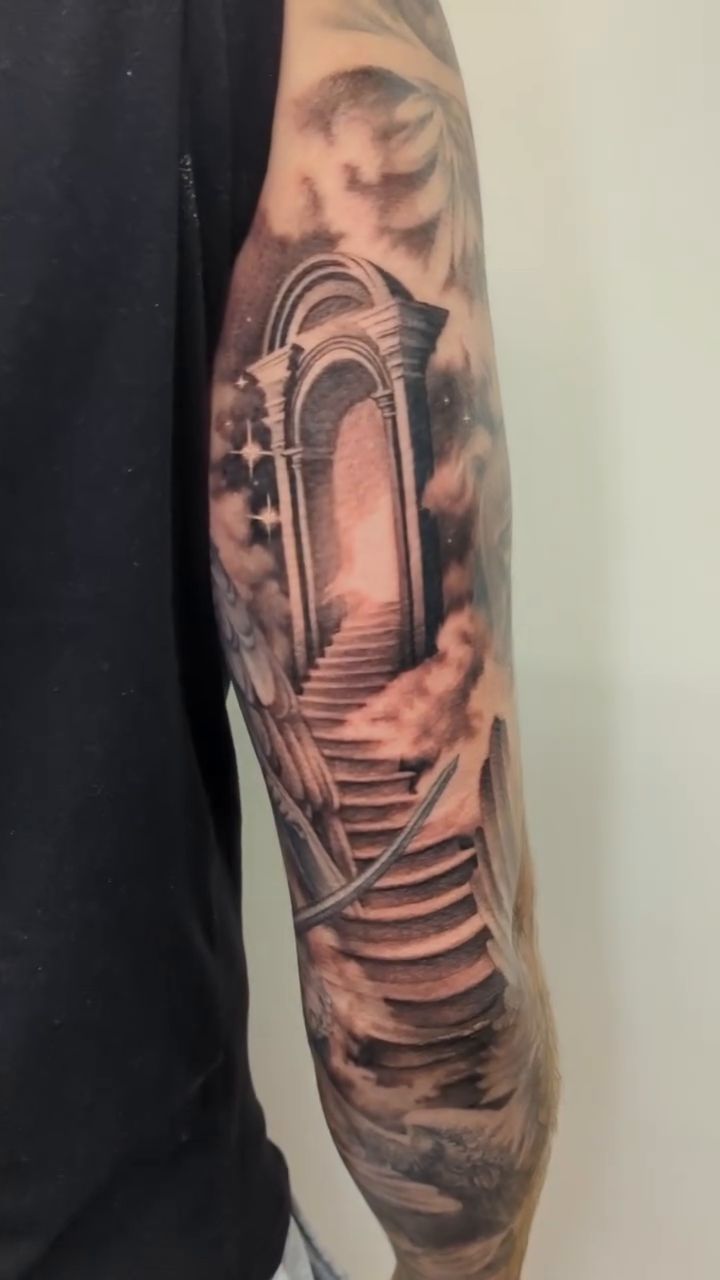 Stairway to heaven with angelic figures realism tattoo by Sean Costello