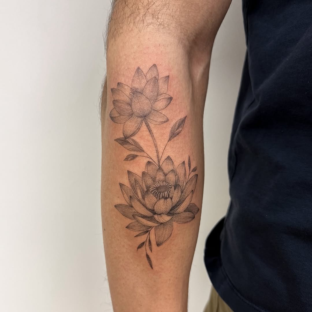 Two lotus flowers fine line tattoo on the forearm by INK by CEE