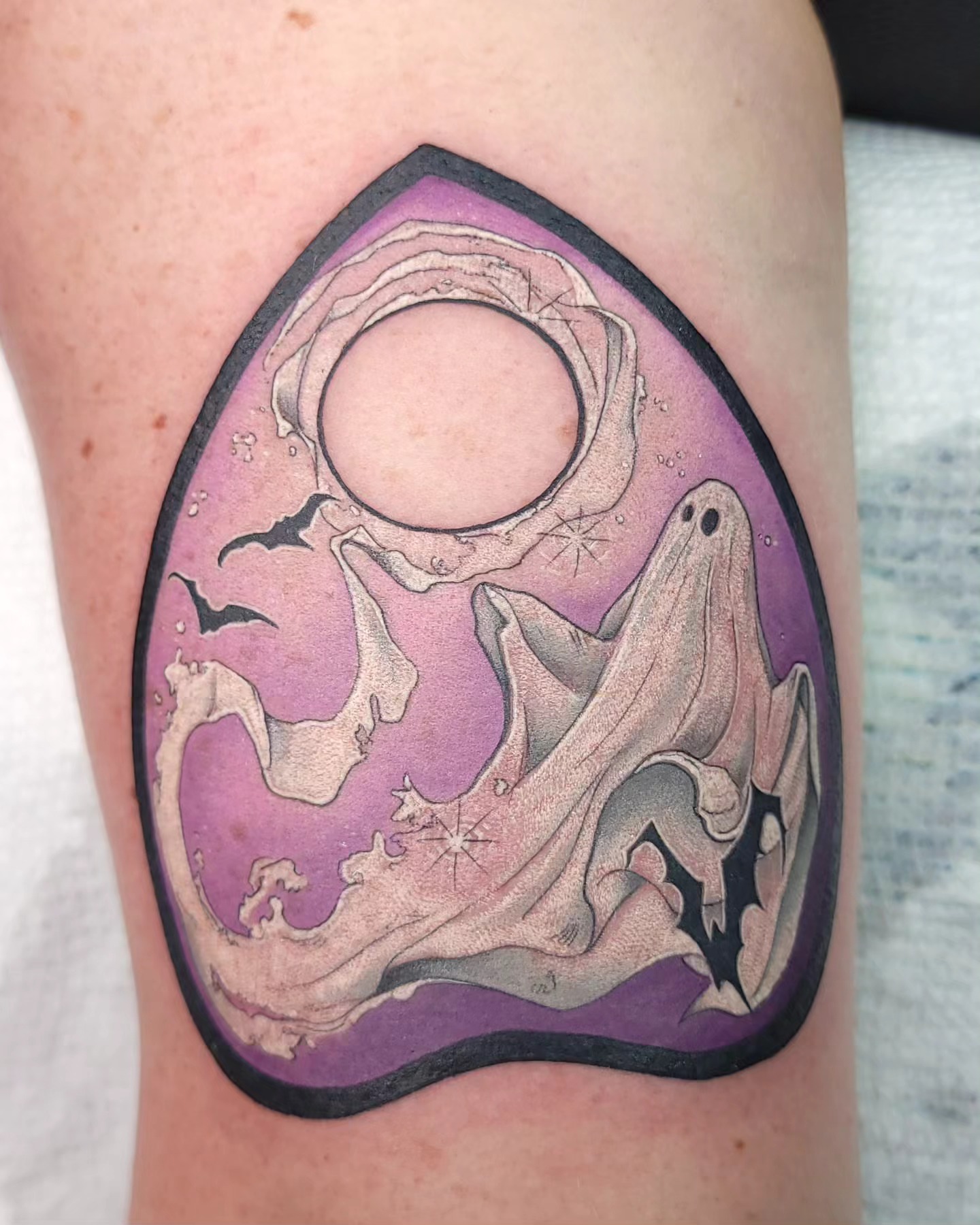 Ghost and moon illustrative tattoo on the thigh by Ghost