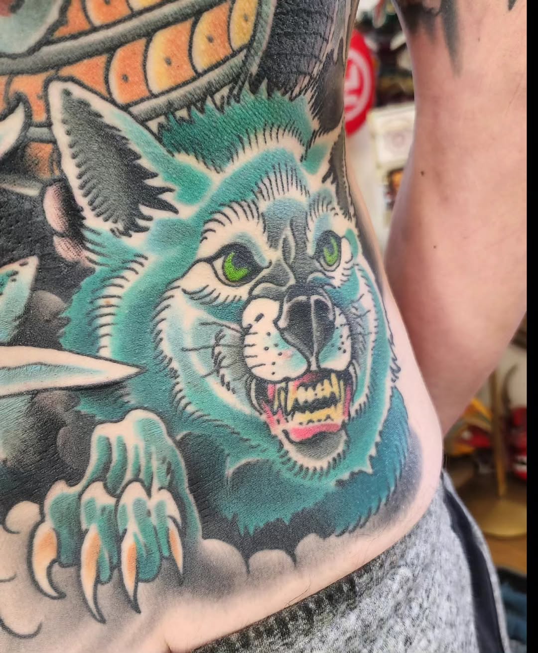 Wolf head with claws realism tattoo on the torso by jeff ensminger