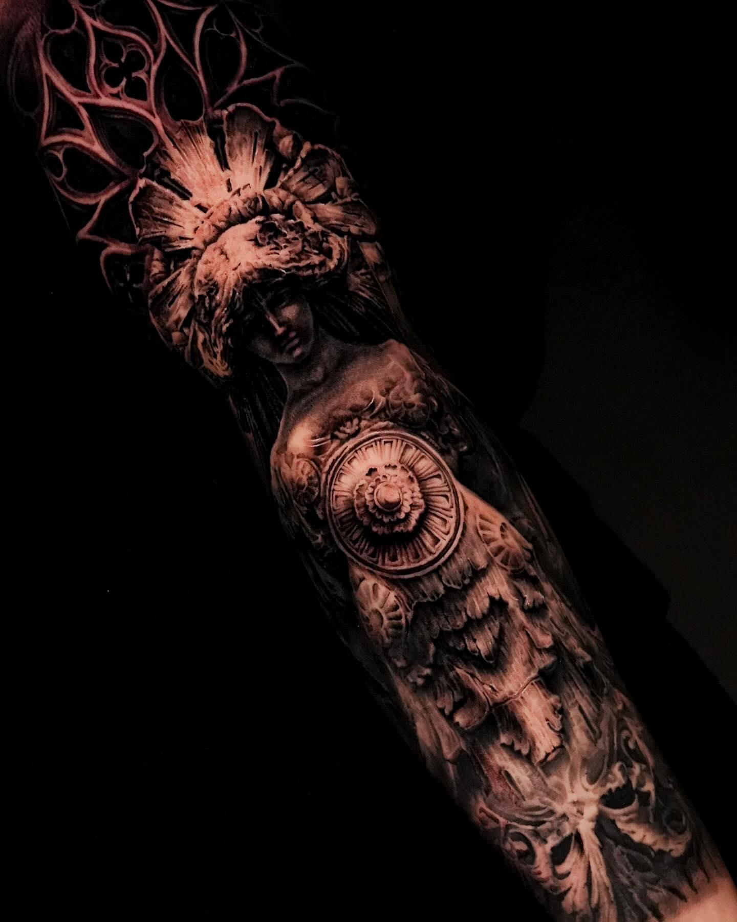 Woman with floral headdress realism tattoo on the forearm by Black and Grey Tattoo Artist Umzii