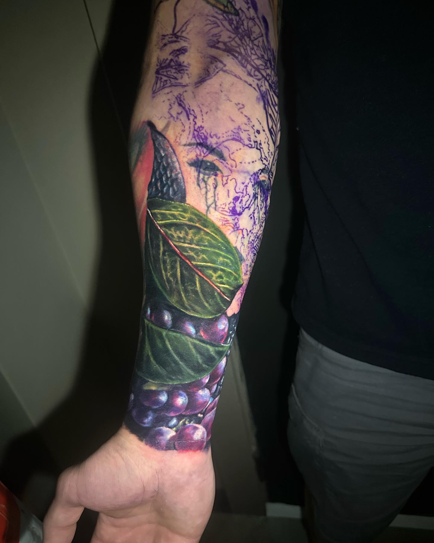 Grapes and leaves realism tattoo on the forearm by Amber Joy (AJ)
