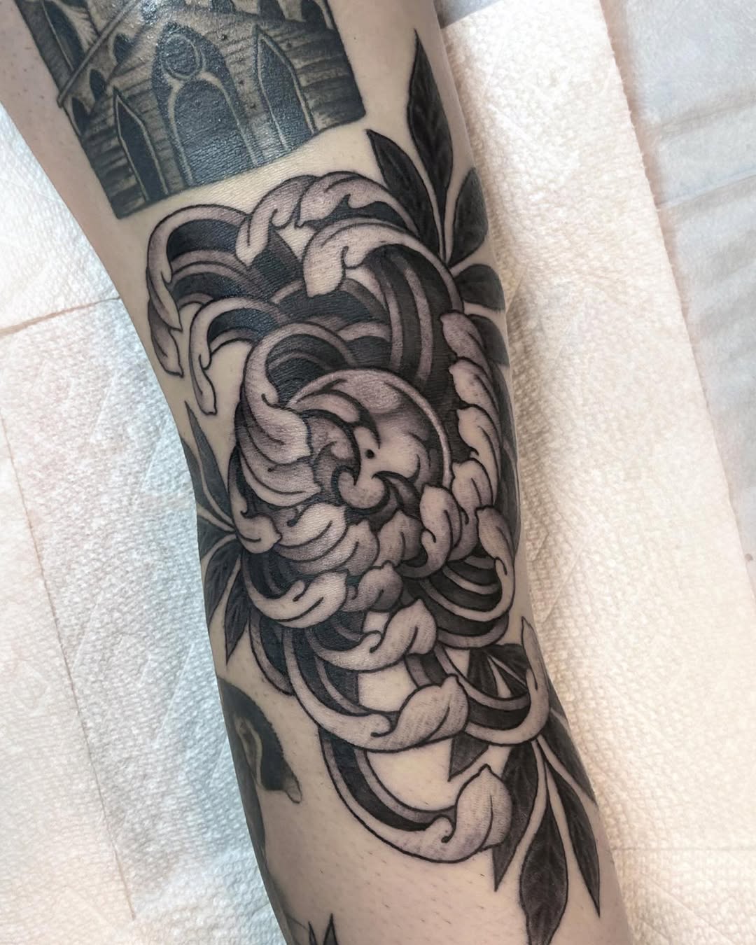 Chrysanthemum flower and waves dotwork tattoo on the forearm by 🦎Langley Osborn Tattoos🦎, Maryville, Tennessee