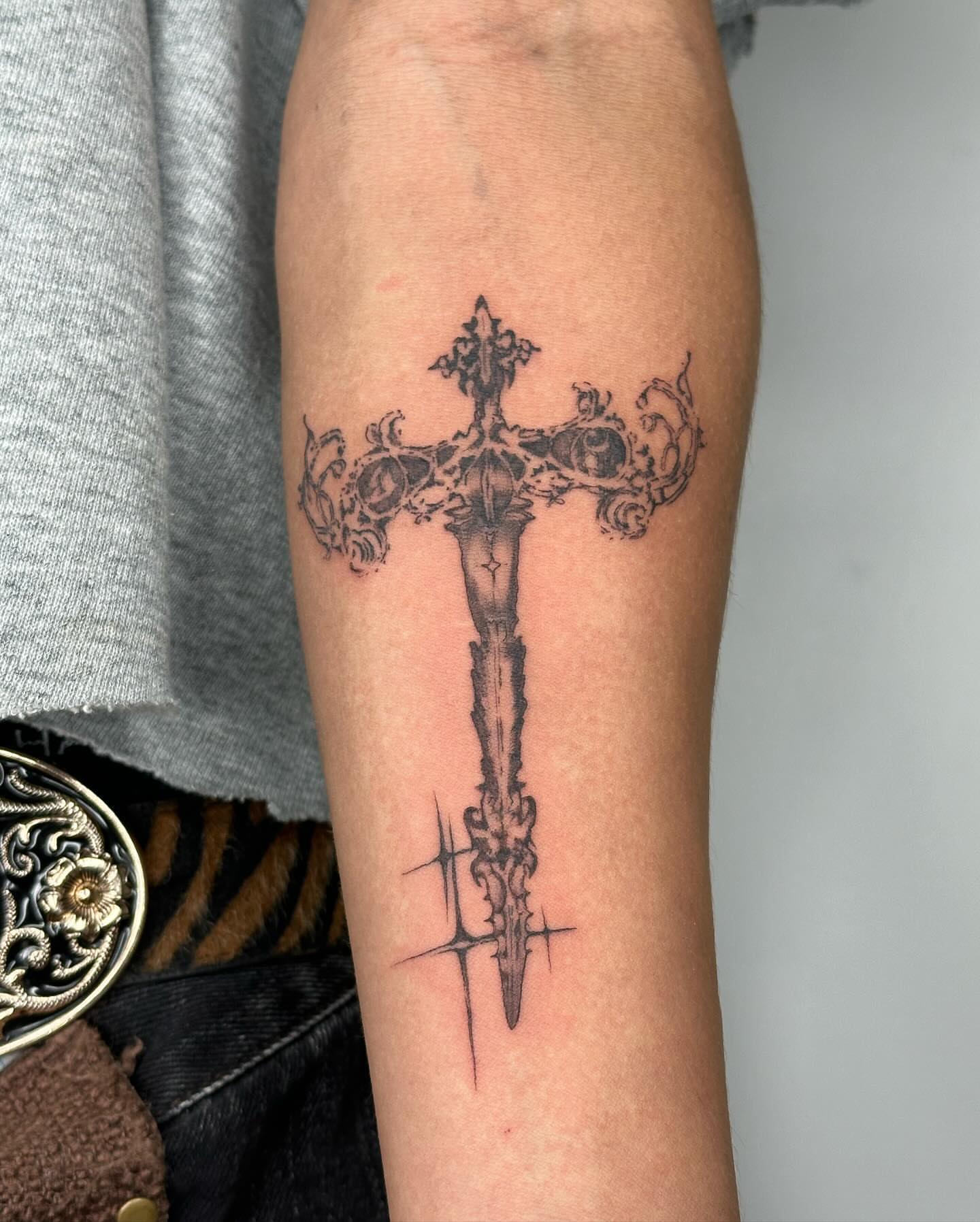 Cross black and grey tattoo on the forearm by sanjai