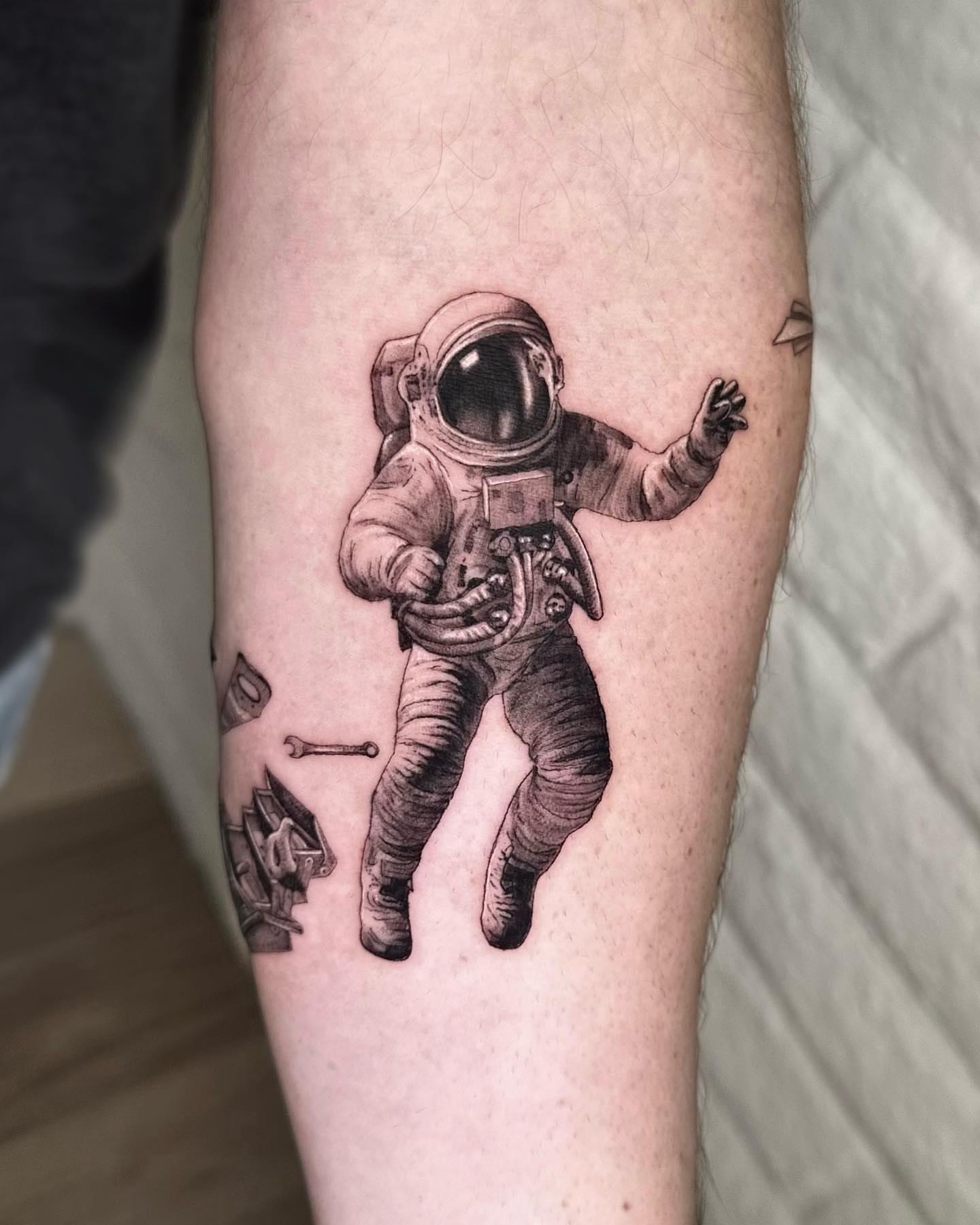 Astronaut realism tattoo on the forearm by Oxana