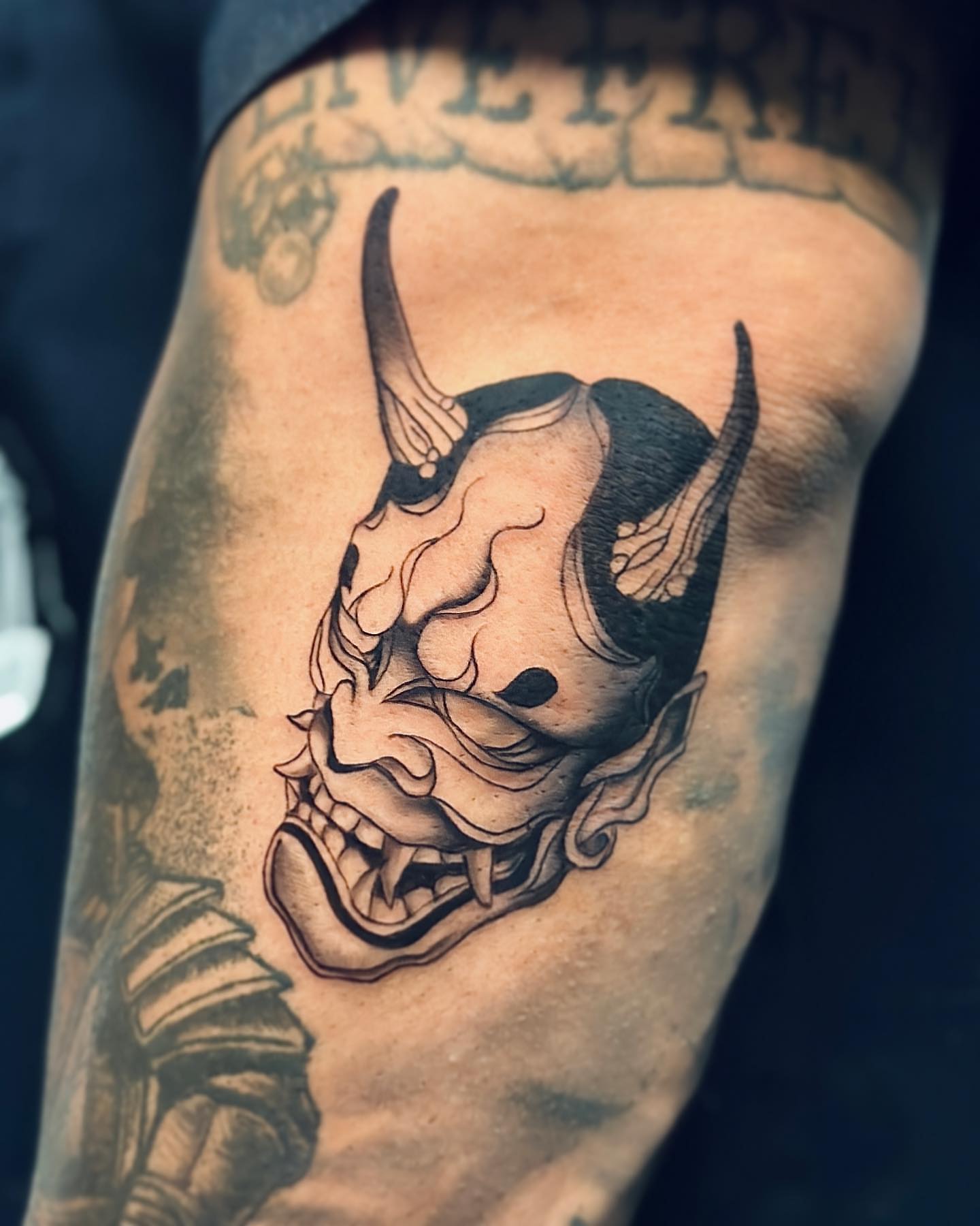 Demon mask realism tattoo on the forearm by Valery Cardona