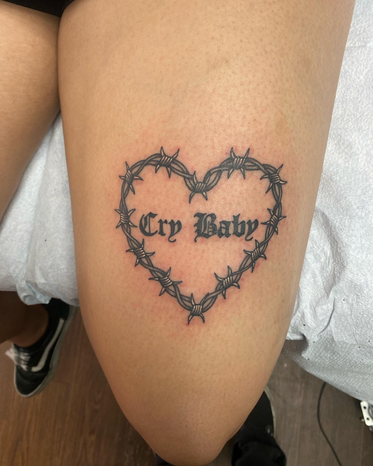 Barbed wire heart black and grey tattoo on the thigh by Payton Prentice