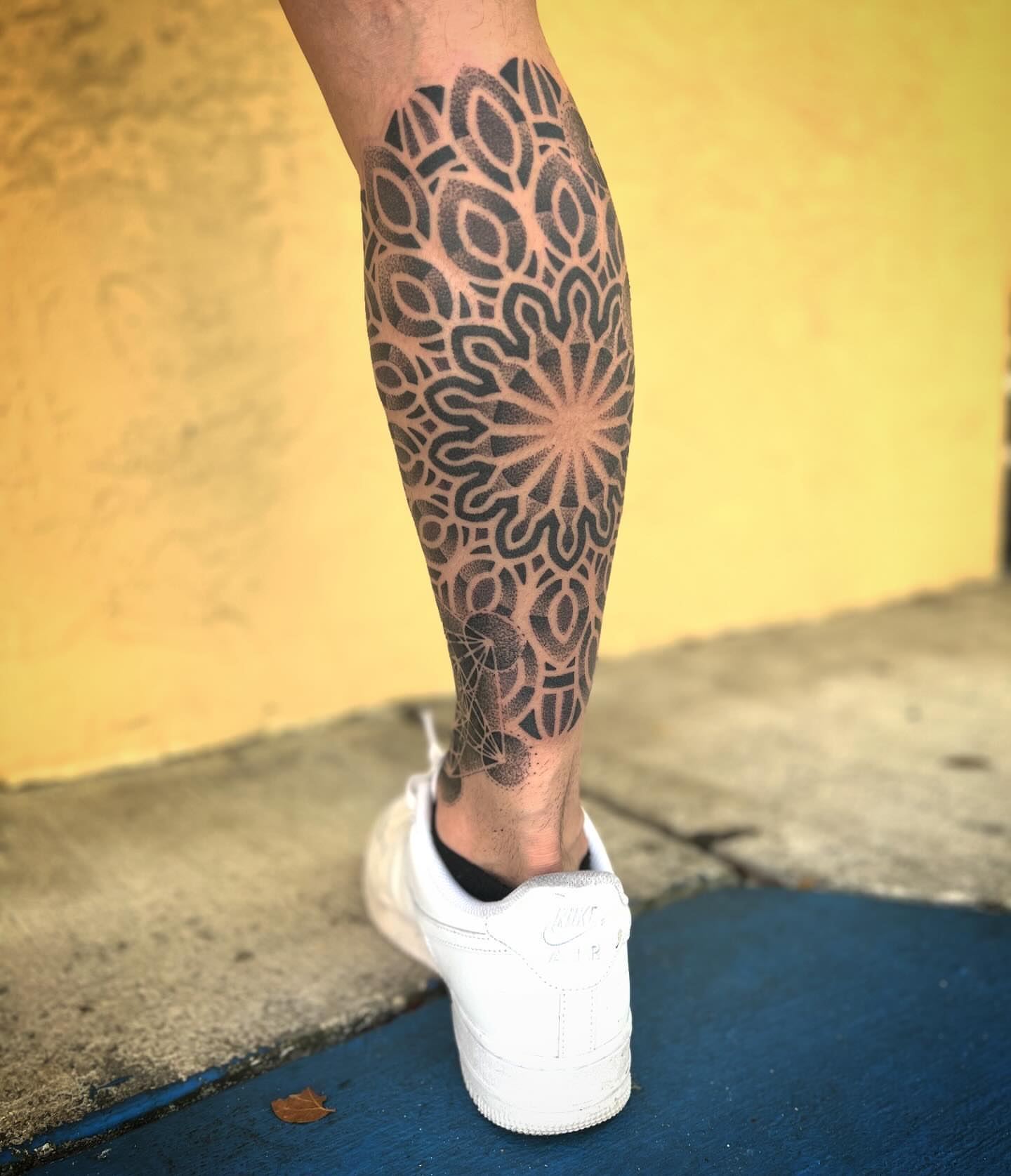 Geometric pattern geometric tattoo on the calf by Paul Schnell