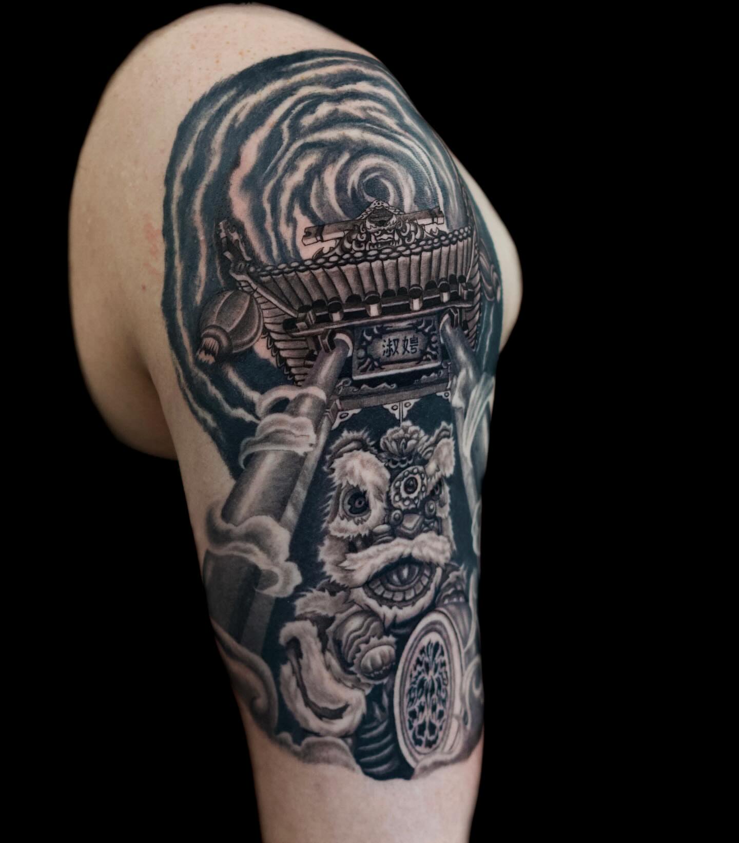 Lion dance realism tattoo on the shoulder by Tattoo Artist