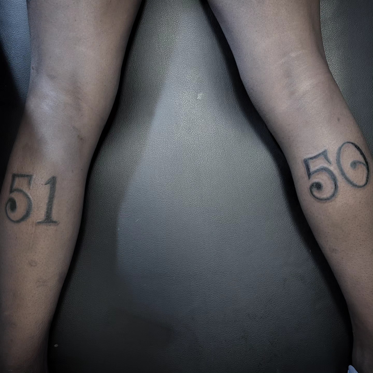 Numbers black and grey tattoo on the upper arm by Markus Hicks