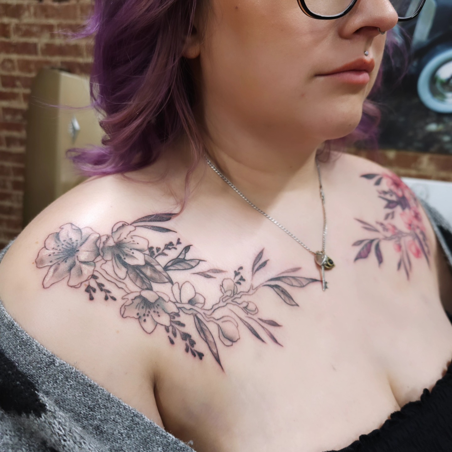 Floral arrangement black and grey tattoo on the chest by Nadine ☥