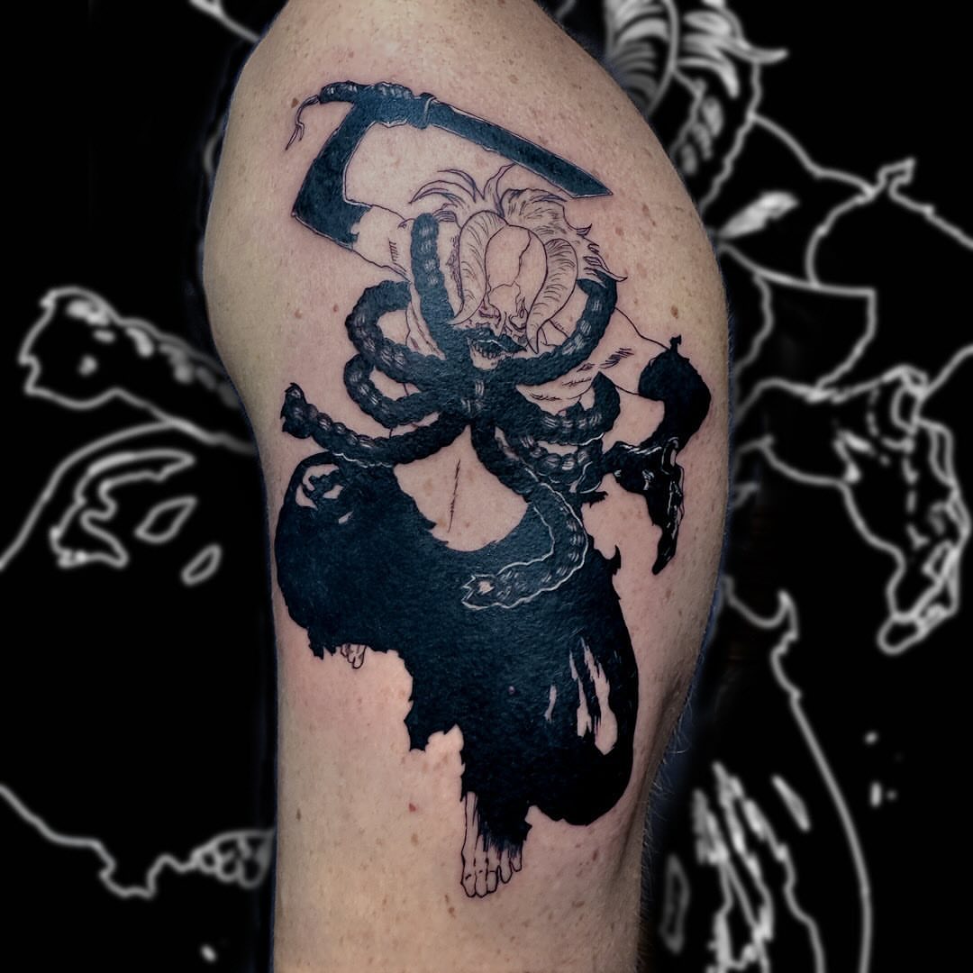 Snake and skull dark realism tattoo on the upper arm by Tattoo Artist Bay Area - Lorenzo, Berkeley, California
