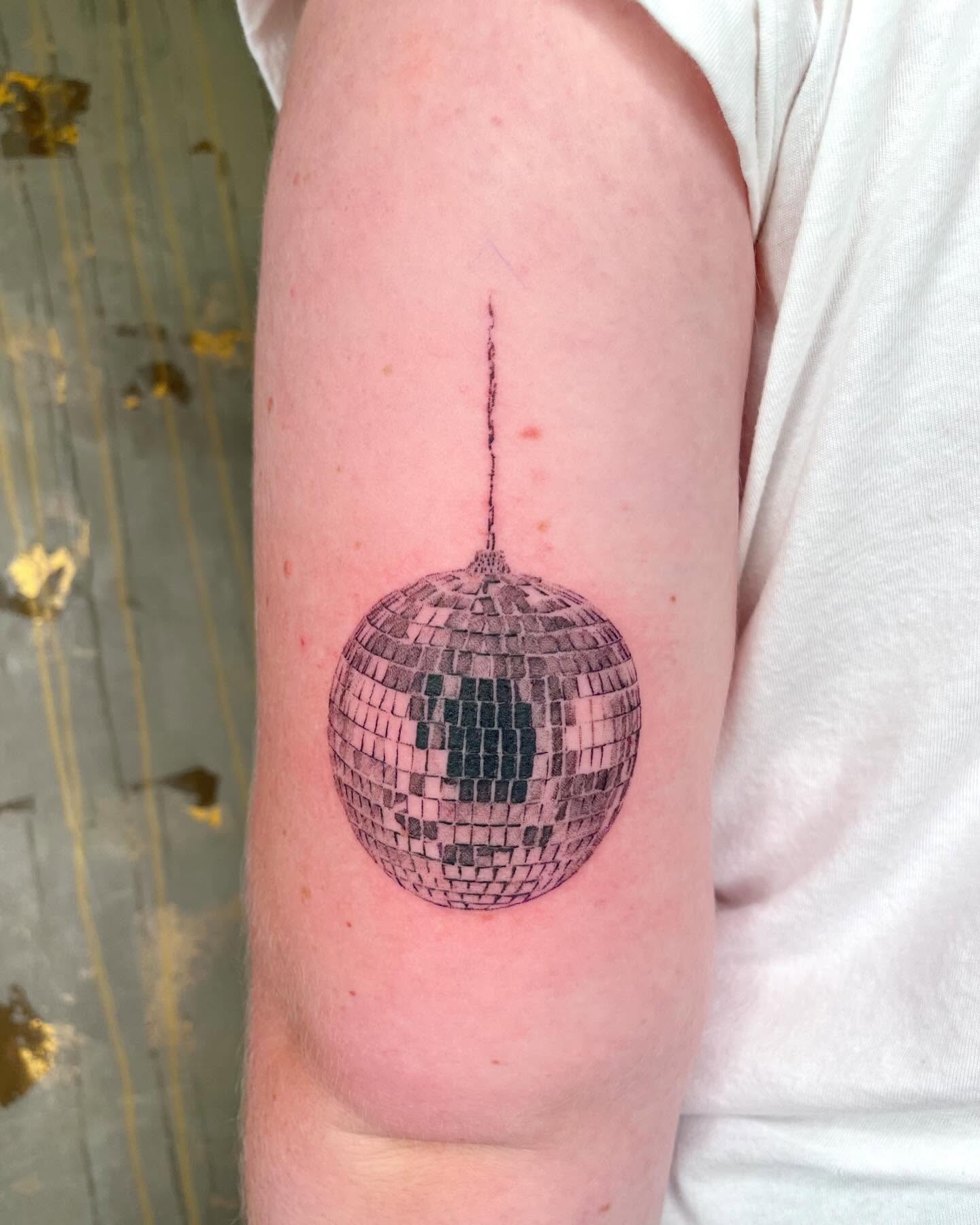 Mirror ball realism tattoo on the forearm by zach arlan, Kansas City, Missouri