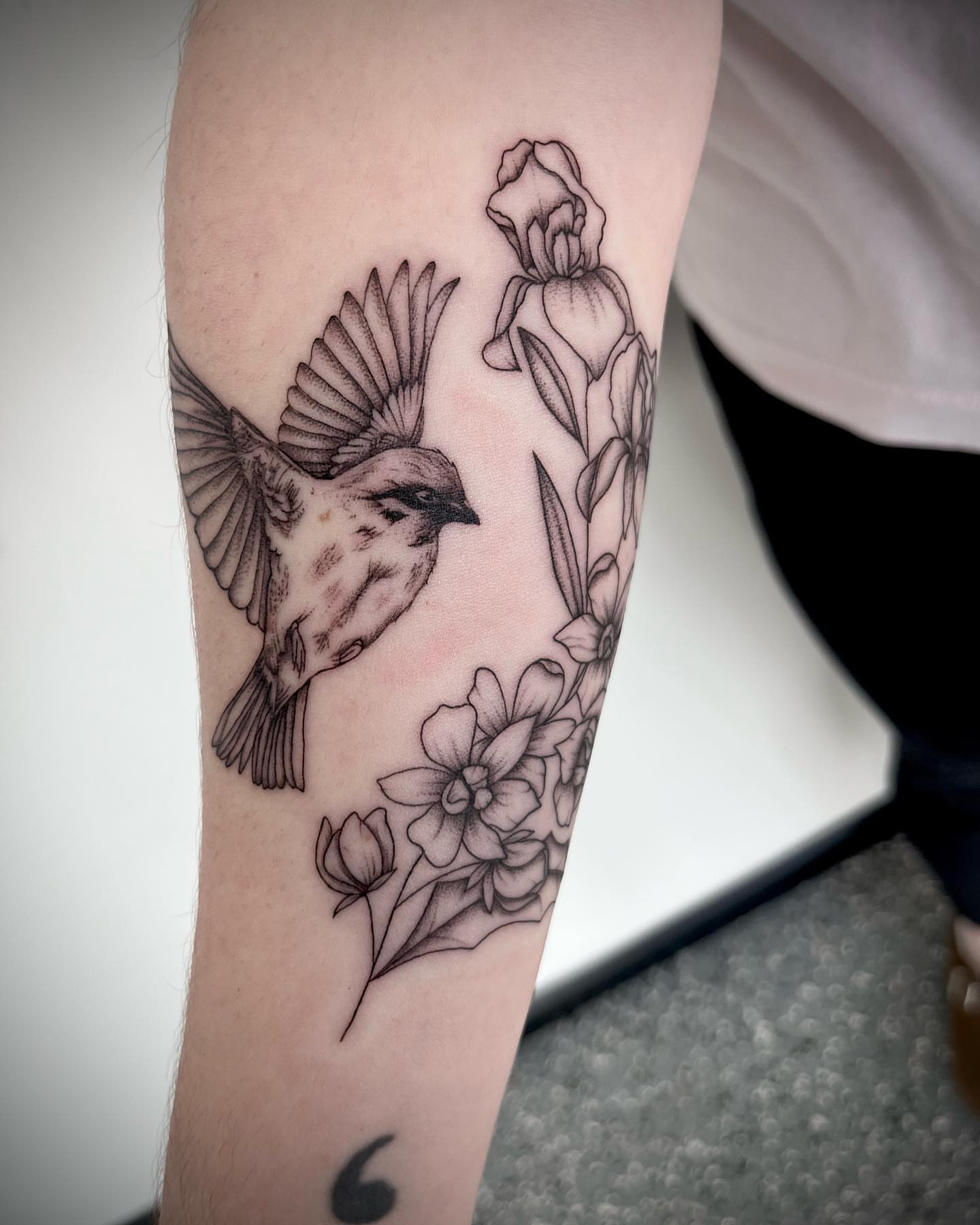 Bird and flowers realism tattoo on the forearm by oh hey, robin.