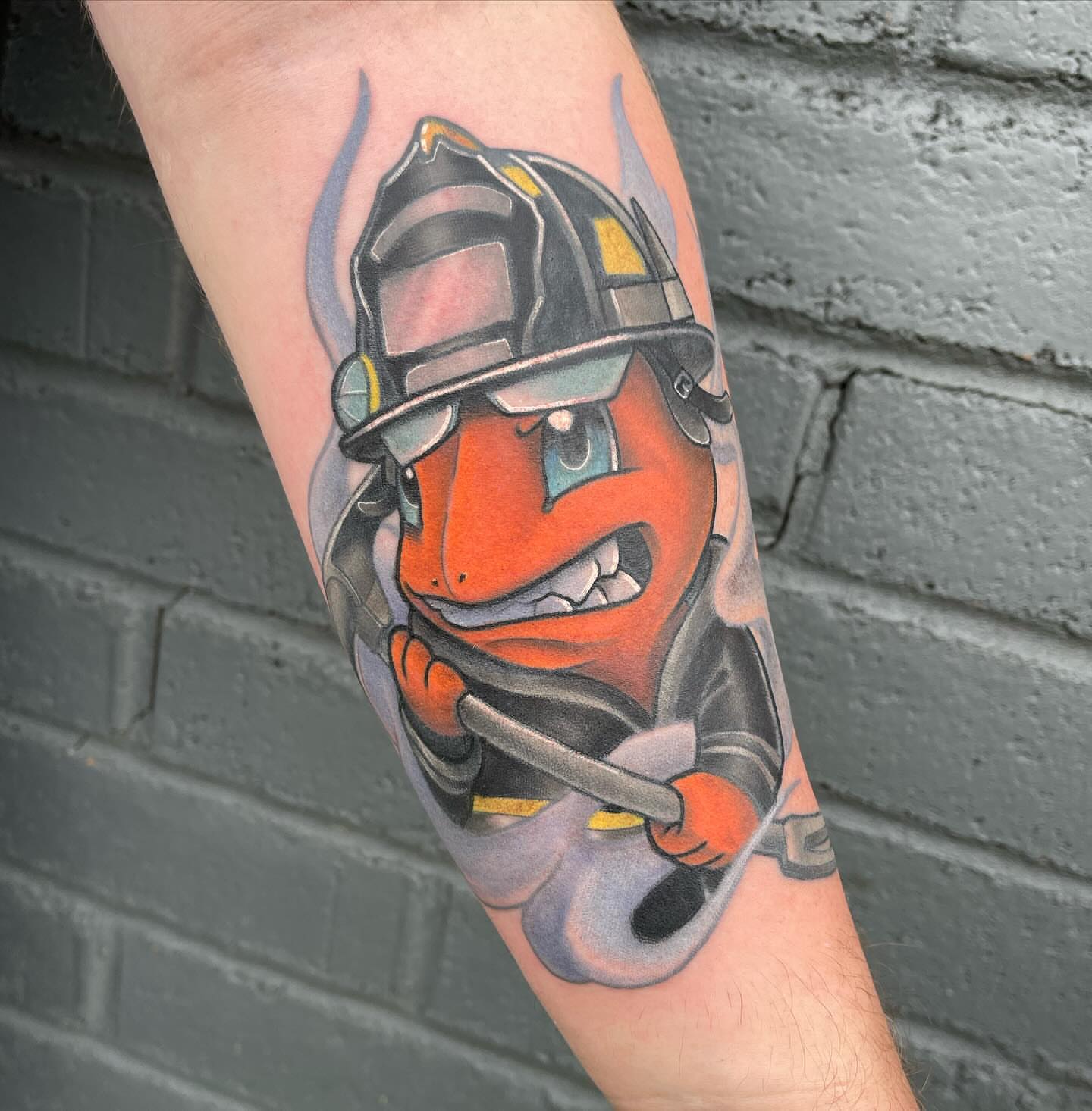 Firefighter helmet realism tattoo on the forearm by Chris Sparks, I just go by Sparks.