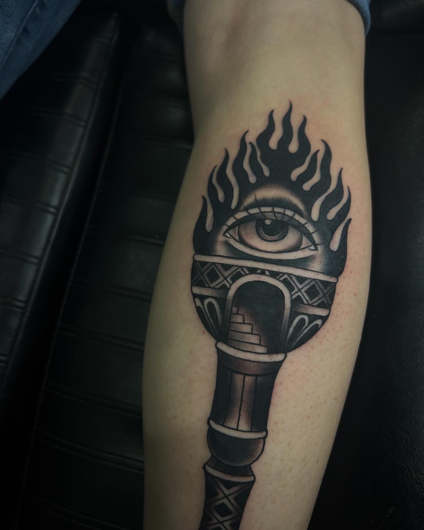 Torch with eye geometric tattoo on the forearm by Samantha C, Bremerton, Washington