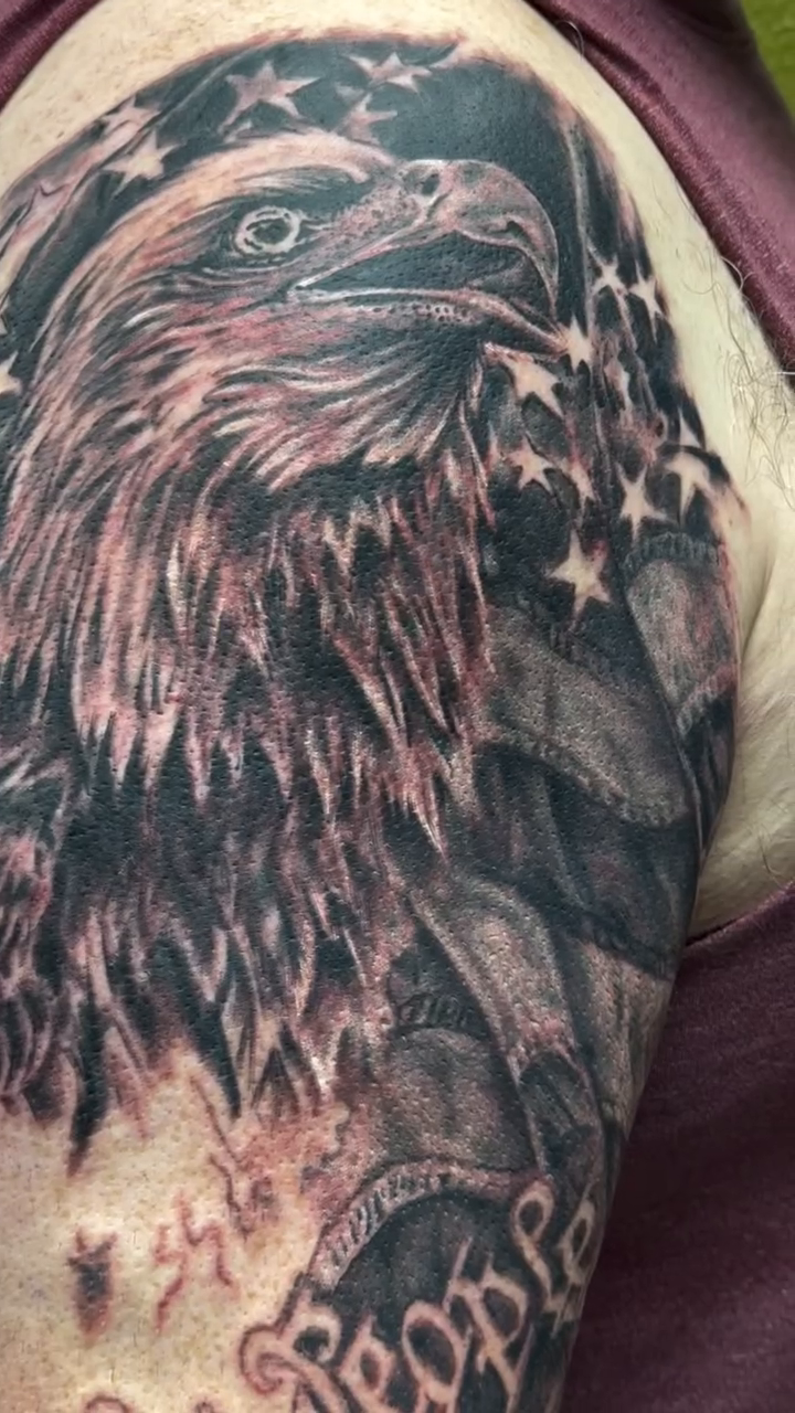 Eagle with American flag realism tattoo by Chris Allen Taylor