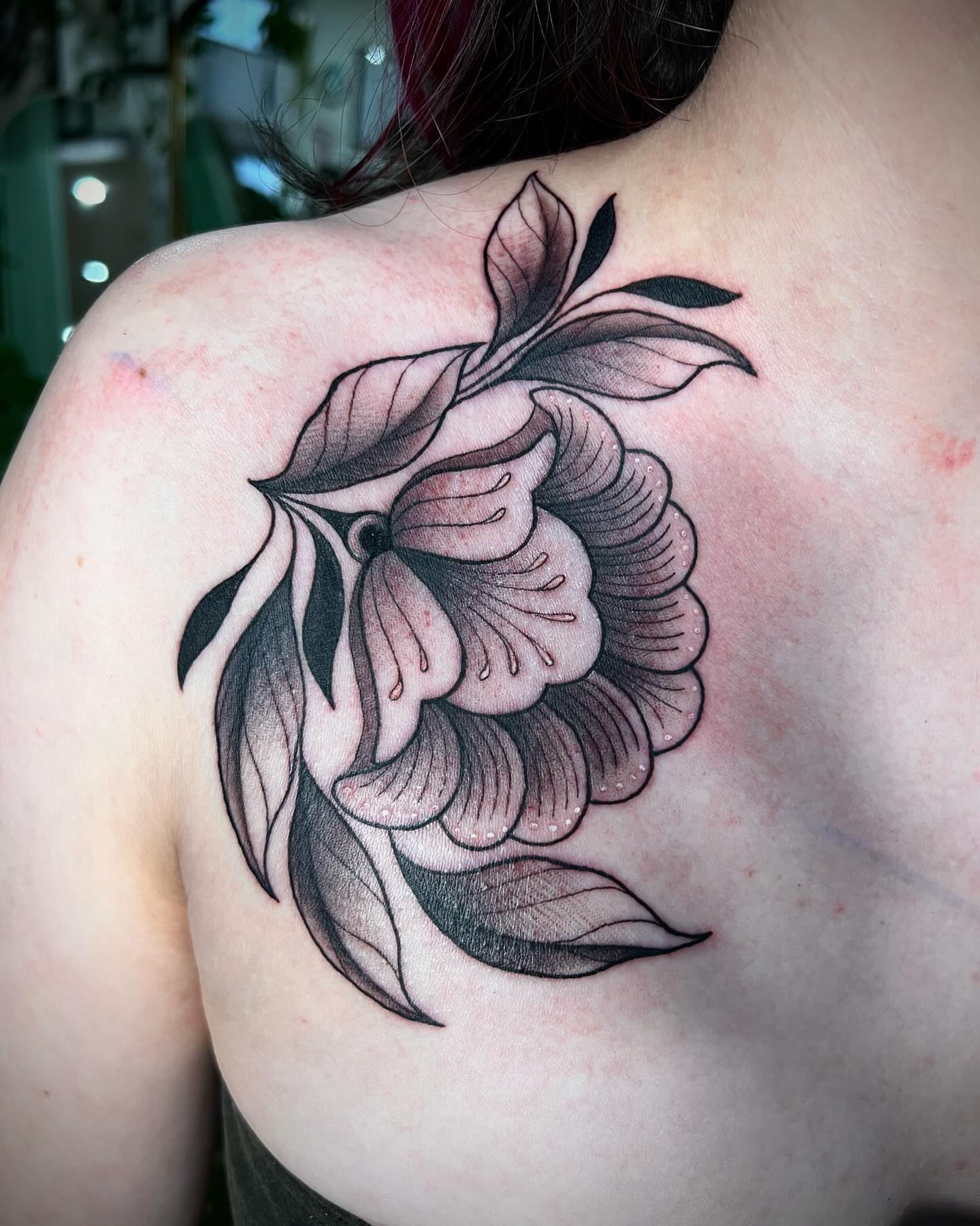 Flower black and grey tattoo on the shoulder by Mia Manzanedo