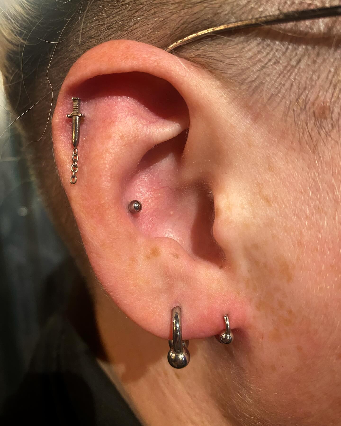 Ear piercing black and grey tattoo by Rylan Thorndyke - Tattoo Artist, Las Vegas, Nevada