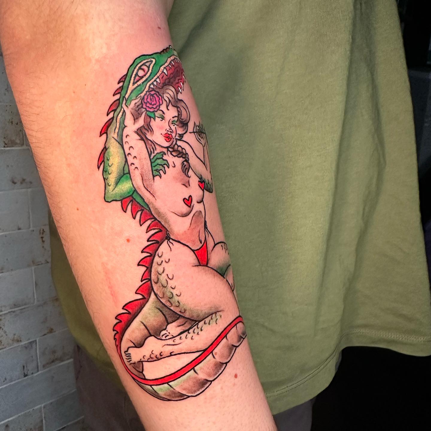 Woman and dragon American traditional tattoo on the forearm by Marta La Jirafa