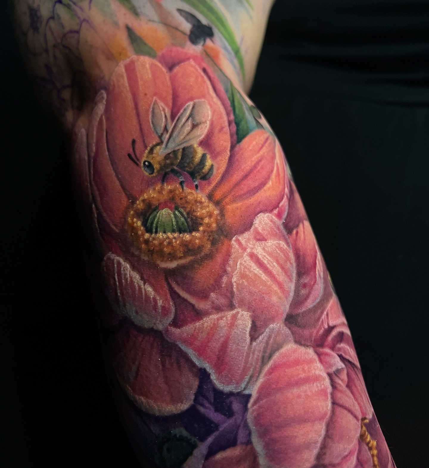 Flower and bee realism tattoo on the forearm by James Hall