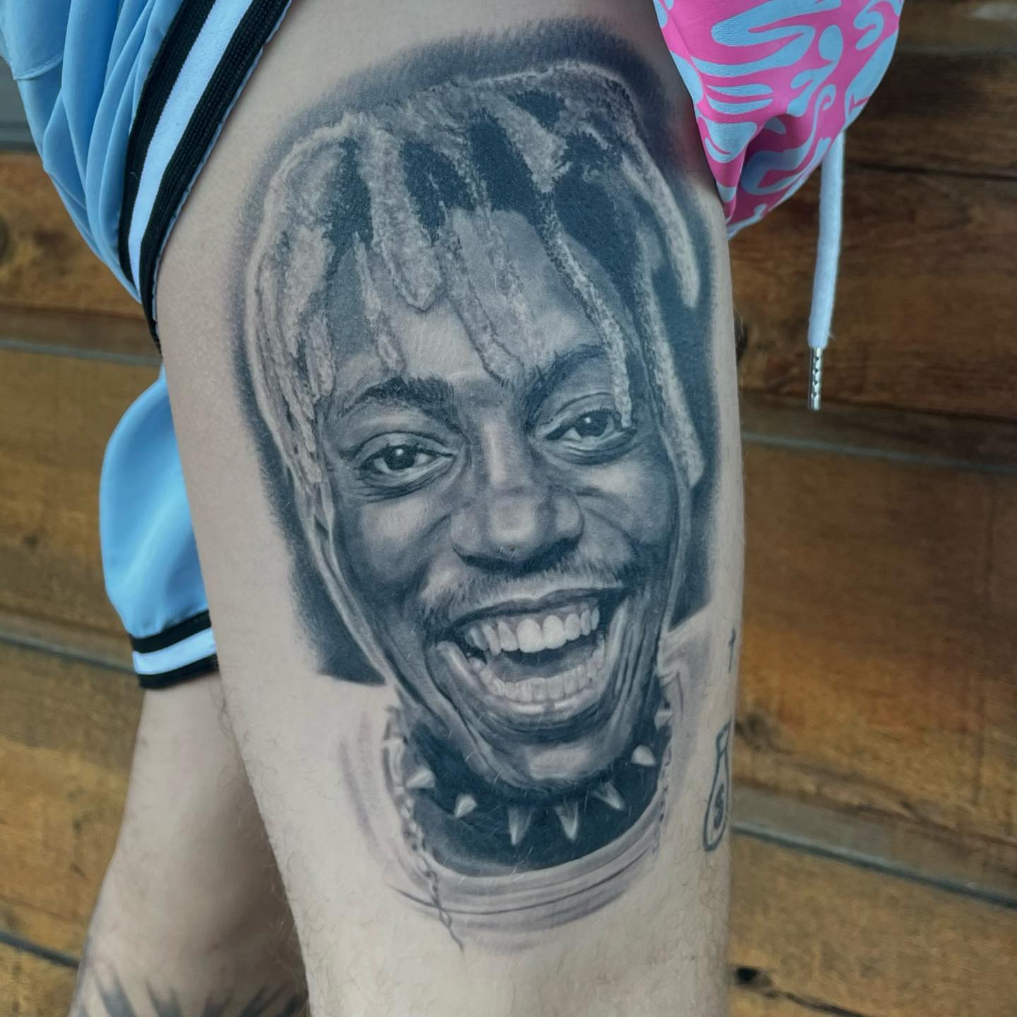 Portrait realism tattoo on the thigh by Jeremiah Warner