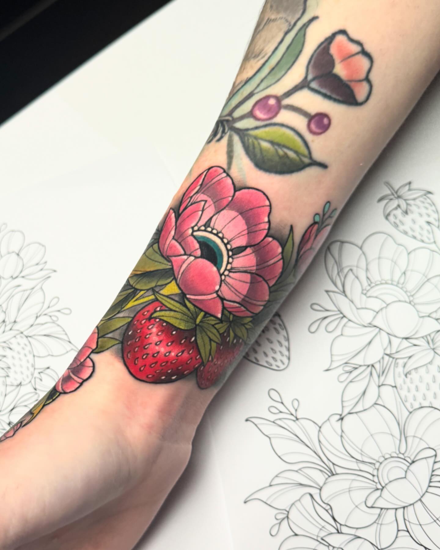 Strawberry and flower bouquet American traditional tattoo on the forearm by James Boag