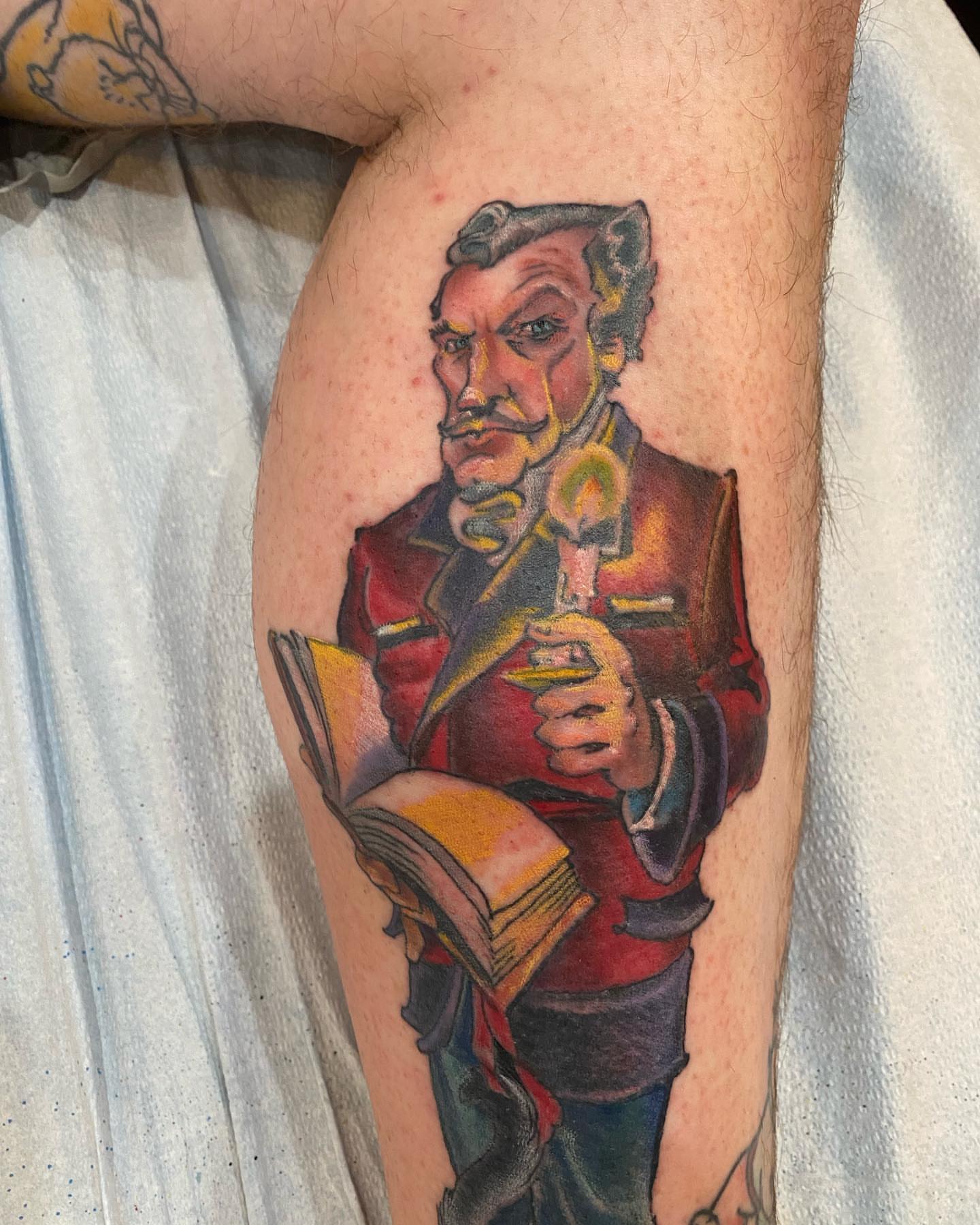 Man reading book realism tattoo on the thigh by Christopher Sanders