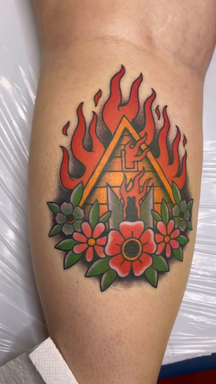 Burning house with flowers American traditional tattoo on the leg by Meghan Schader 🦩🐊