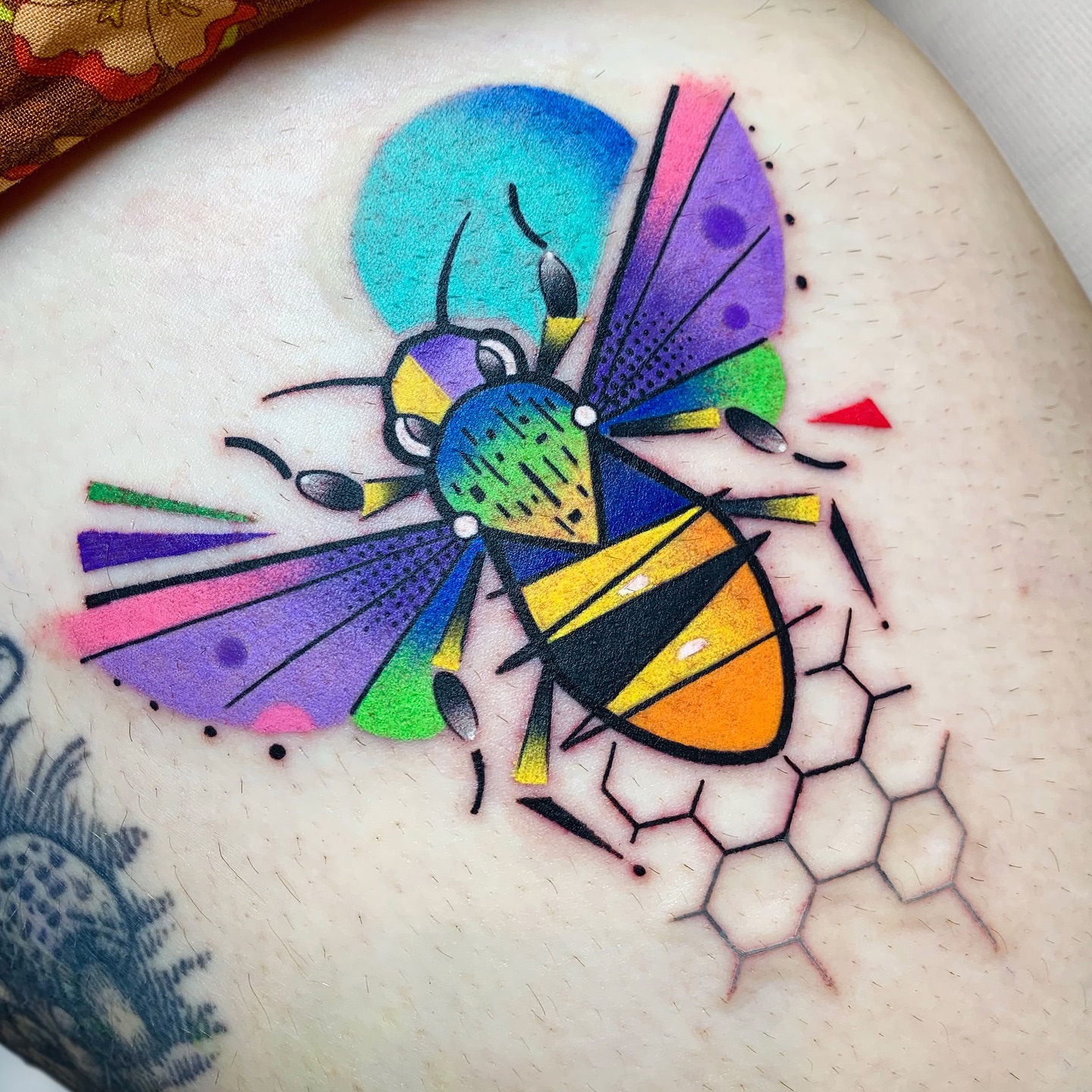 Bee geometric tattoo on the upper arm by hurjaesae
