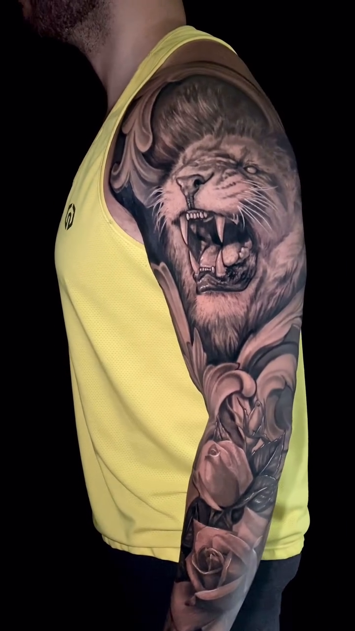 Lion and roses sleeve realism tattoo by Caitlyn Campbell