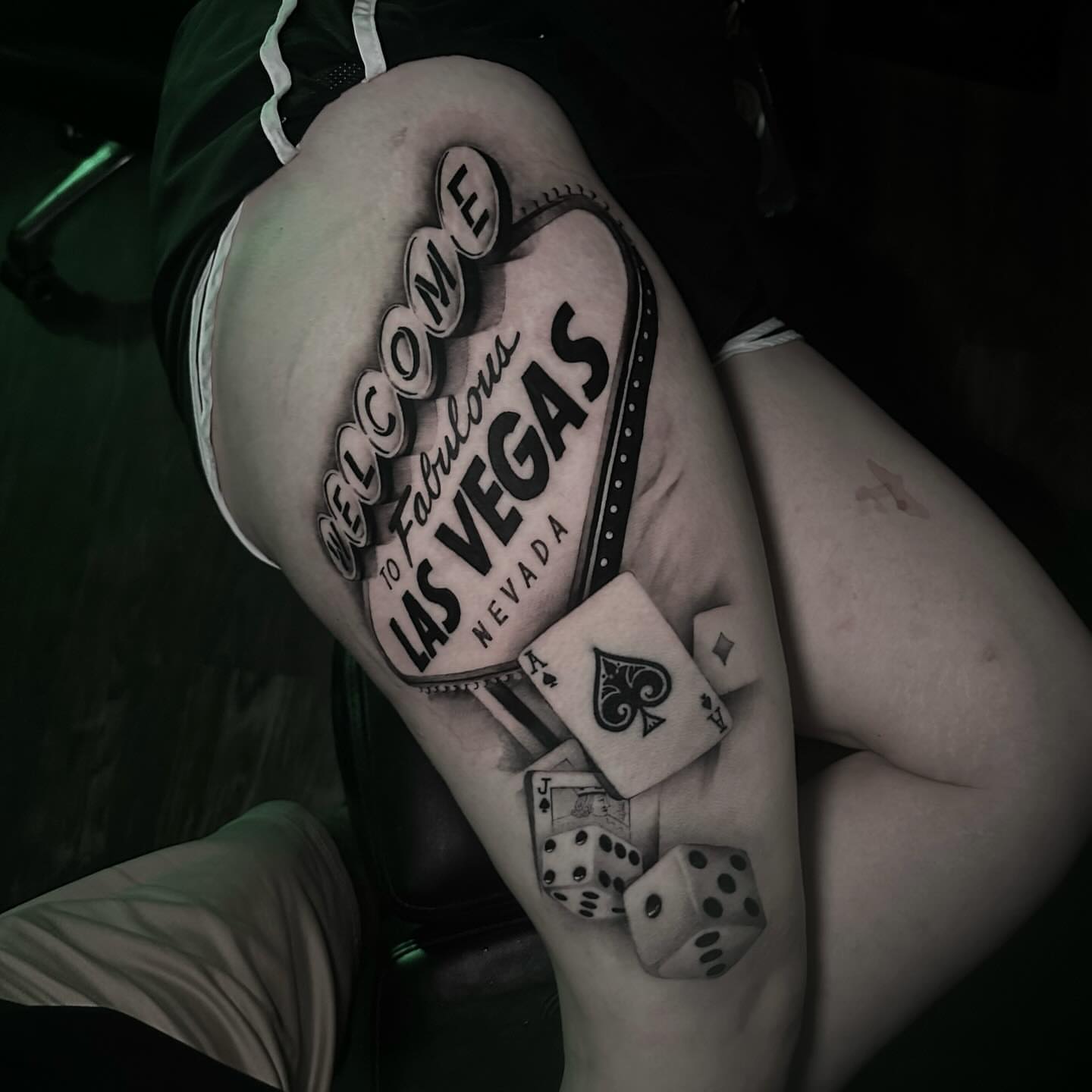 Welcome sign black and grey tattoo on the thigh by Clayton Smith (BEAR)