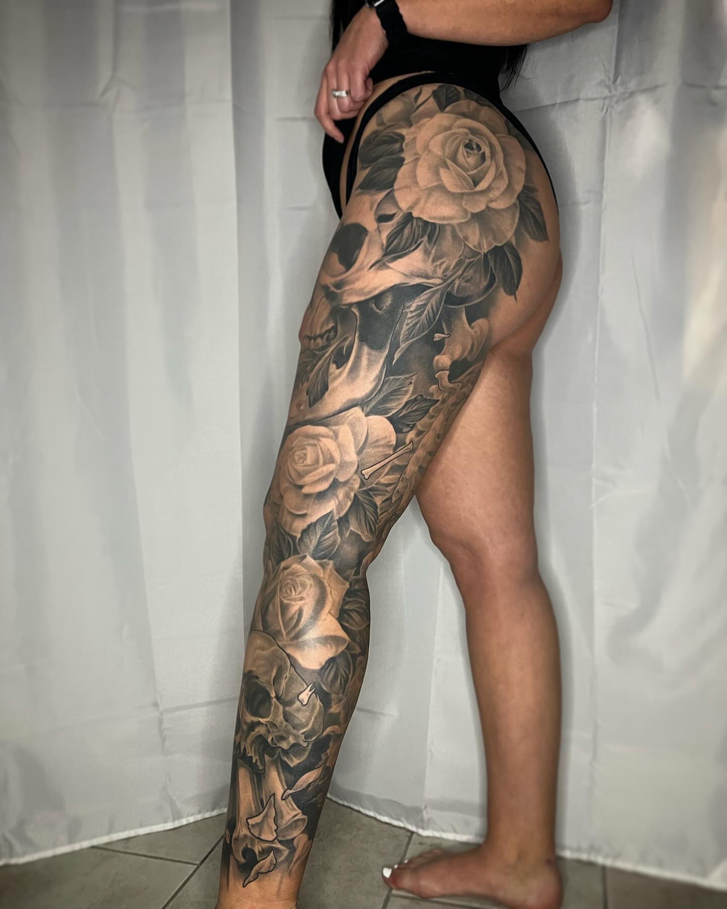 Roses and skulls realism tattoo on the leg by biggstattoos